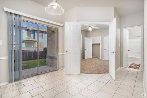 Open entryway with tile flooring and patio access at Houston Street Townhomes Apartments, Texas