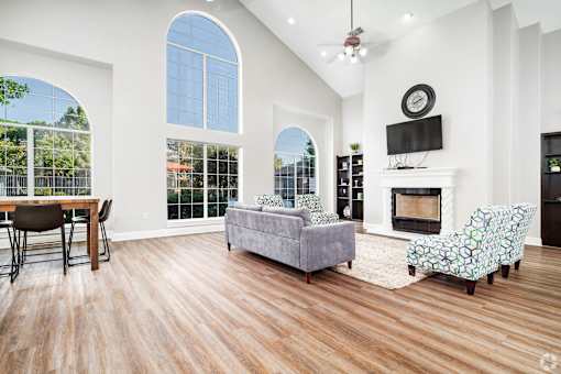 Living room with vaulted ceiling and fireplace at Houston Street Townhomes Apartments, San Antonio, TX