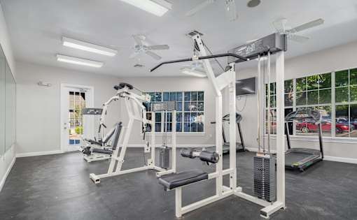 Fitness center with weight machines and cardio equipment at Houston Street Townhomes Apartments, San Antonio, 78220