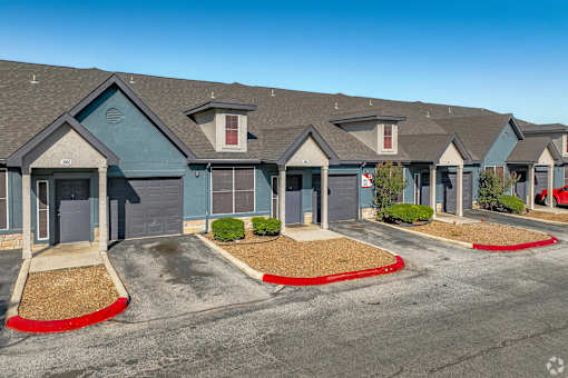 Townhome exteriors with garages and landscaping at Houston Street Townhomes Apartments, Texas, 78220