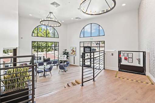 A room with a black gate and a wooden floor.
