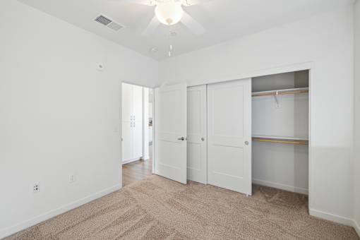 A room with white walls and a carpeted floor.