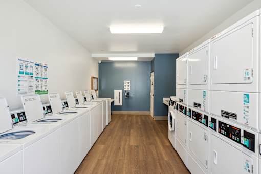 Laundry room with multiple washers and dryers