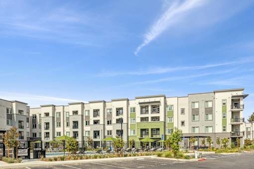 an image of an apartment building with a blue sky in the background