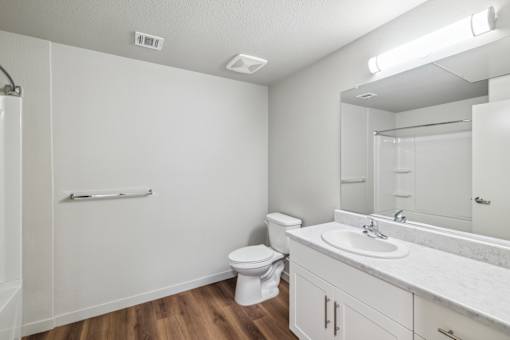 an empty bathroom with a toilet sink and mirror