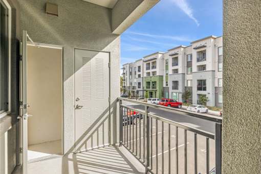 the view from the balcony of an apartment building with a street