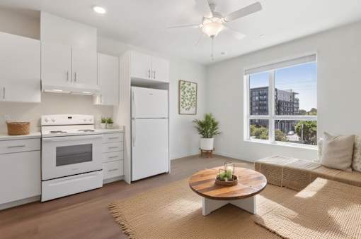 A modern kitchen with white appliances at Mainline North Apartments - Santa Clara, CA, California