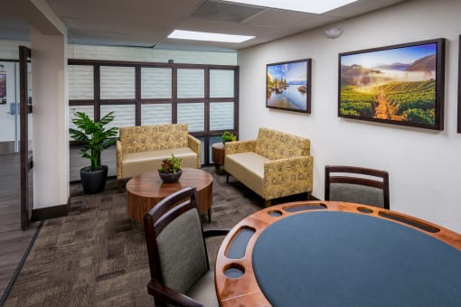 The Sierra Sunrise Senior Apartments sign lobby area, with seating and a poker table