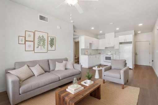 A living room with a grey couch and a coffee table.
