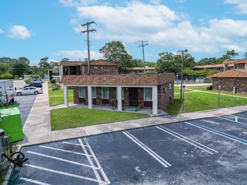 an empty parking lot in front of a brick building