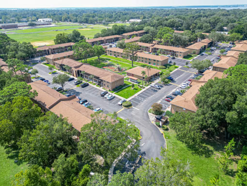 an aerial view of a city with buildings and a parking lot