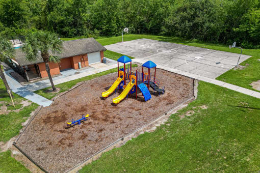 an aerial view of a playground and a parking lot