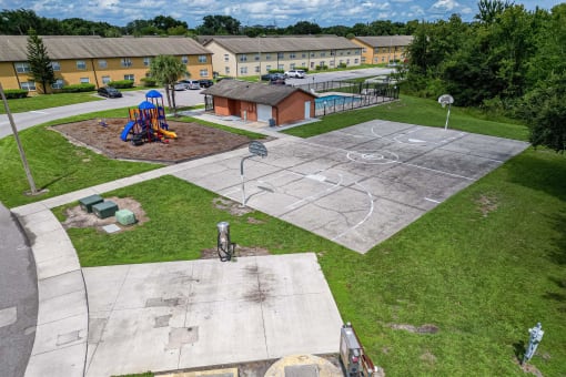 an aerial view of a basketball court in a park