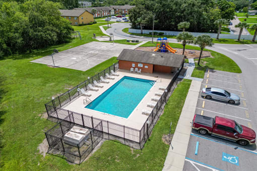 an aerial view of a swimming pool in a parking lot