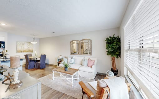 a living room with white furniture and a large window at Island Club Apartments, Columbus, OH, 43235