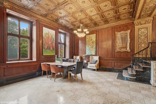 a dining room with wood paneled walls and a table with chairs  at The Embassy in St Louis