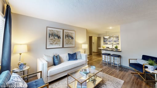 a living room with a couch and a glass table at Silvertree at Little Turtle Apartments, Ohio
