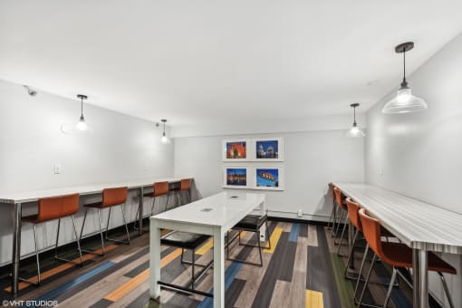 A conference room and office with white table and chairs at Delmar Loop Apartments, Missouri, 63112