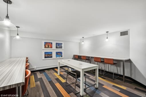 a conference room with a white table and chairs at Delmar Loop Apartments, St. Louis