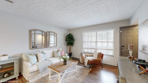 a living room with a couch and a coffee table at Island Club Apartments, Ohio