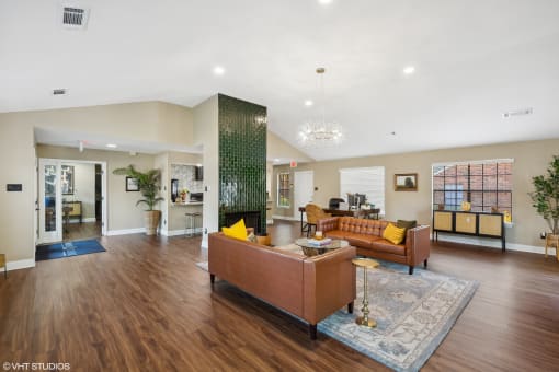 a living room with a leather couch and a fireplace at The Birches Apartment Homes, Memphis, TN, 38133