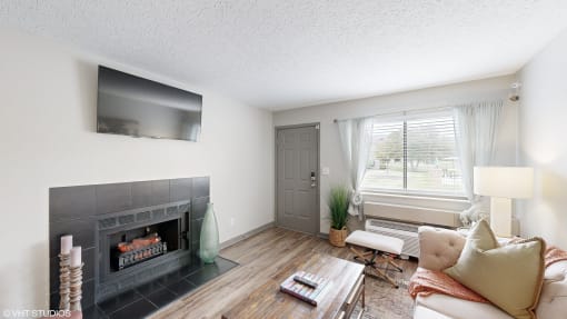 a living room with a fireplace and a tv at Karric Place of Dublin Apartments, Dublin, Ohio