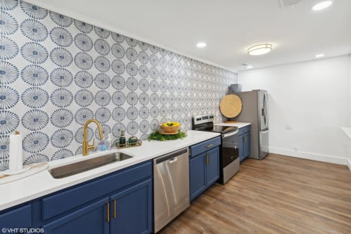 a kitchen with blue cabinets and a white counter top and a sink at The Stella, Memphis, TN, 38134