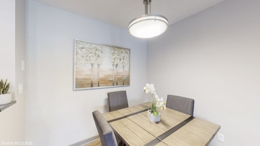 a dining room with a wooden table and chairs at Island Club Apartments, Columbus, OH