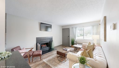 a living room with a couch and a fireplace at Karric Place of Dublin Apartments, Ohio