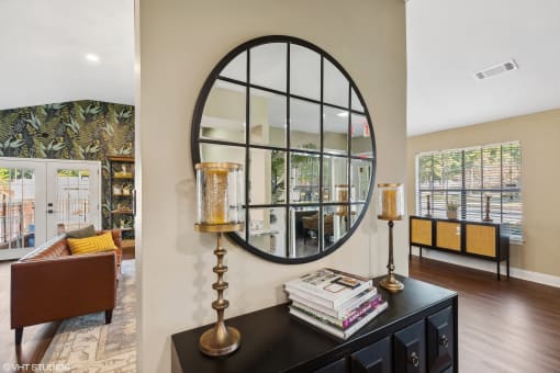 a living room with a large circular mirror on the wall at The Birches Apartment Homes, Tennessee, 38133