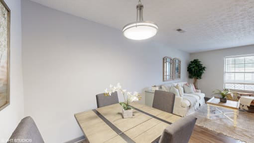 an open living room and dining room with a couch and a table at Island Club Apartments, Ohio