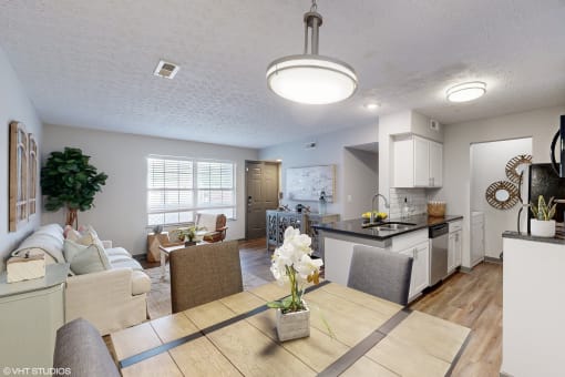a living room and kitchen with a dining room table and chairs and a kitchen at Island Club Apartments, Columbus, OH