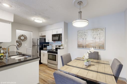 an open kitchen and dining room with a table and chairs at Island Club Apartments, Columbus, Ohio