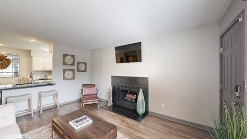 a living room with a fireplace and a table and chairs at Karric Place of Dublin Apartments, Dublin, OH