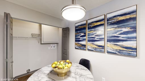 a kitchen with a table and a bowl of fruit on it at Silvertree at Little Turtle Apartments, Ohio