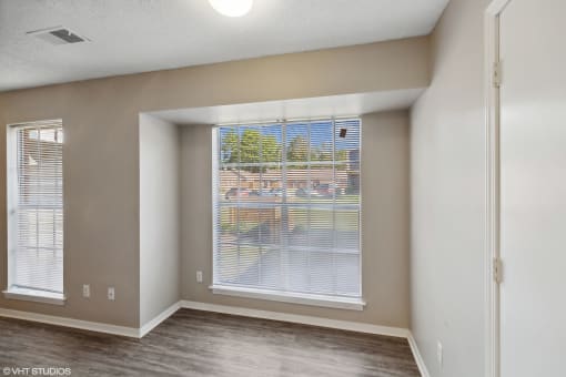 an empty living room with a large window at The Birches Apartment Homes, Tennessee