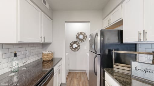 a kitchen with white cabinets and stainless steel appliances at Island Club Apartments, Columbus, 43235