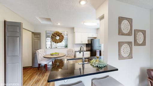 an open kitchen and living room with a table and chairs at Karric Place of Dublin Apartments, Dublin, OH