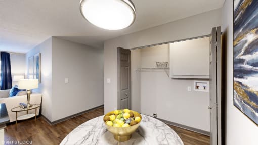 a living room with a table with a bowl of fruit on it at Silvertree at Little Turtle Apartments, Westerville, Ohio