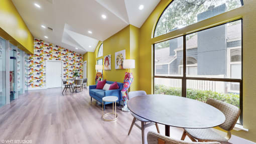 a living room with yellow walls and a dining room with a table and chairs at The Vale, Cordova, 38018