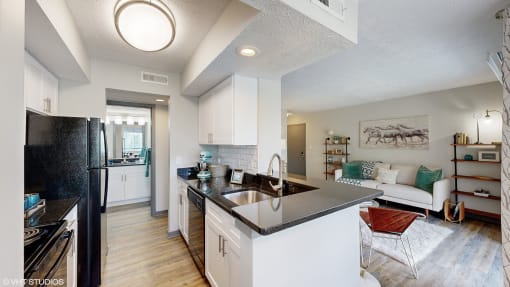 an open kitchen and living room with a black counter top at Runaway Bay Apartments, Columbus, 43204