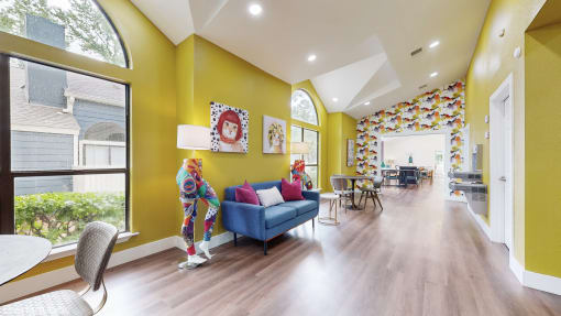a living room with yellow walls and a blue couch at The Vale Apartments and Townhomes, Tennessee