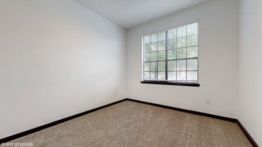 an empty room with a window and carpet at Bristol On Union Apartment Homes, Tennessee, 38104