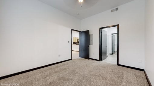 a living room with white walls and a carpet and a door way to a bathroom at Bristol On Union Apartment Homes, Tennessee