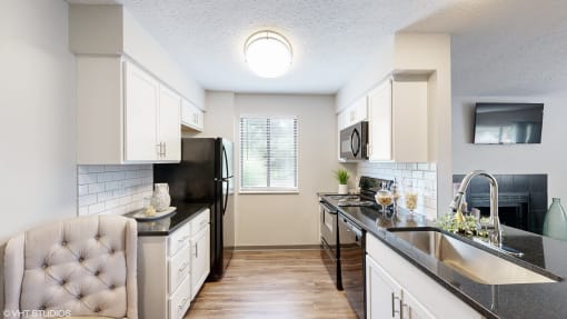 a kitchen with white cabinets and a black counter top at Karric Place of Dublin Apartments, Dublin, OH, 43016
