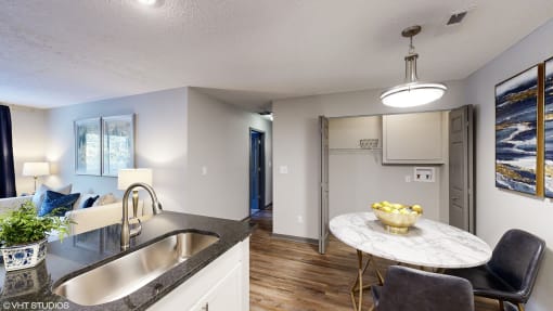 a kitchen and living room with a sink and a refrigerator at Silvertree at Little Turtle Apartments, Westerville