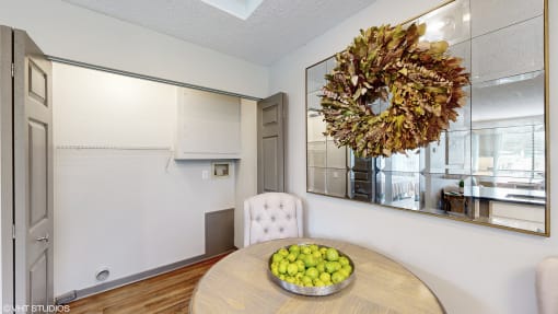 a dining room with a bowl of fruit on the table at Karric Place of Dublin Apartments, Dublin, Ohio