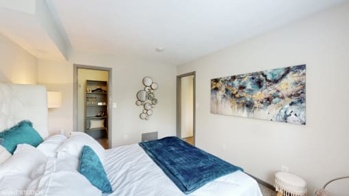 a bedroom with a large bed and a painting on the wall at Runaway Bay Apartments, Ohio