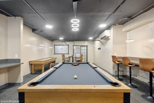a game room with a pool table and a scoreboard  at The Embassy in St Louis