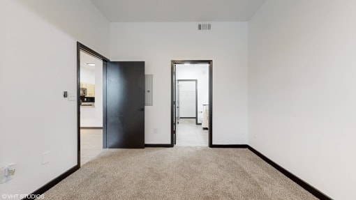 a bedroom with white walls and black doors and a carpeted floor at Bristol On Union Apartment Homes, Memphis, Tennessee